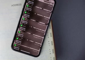 A phone displaying multiple missed calls from "Spam Risk"