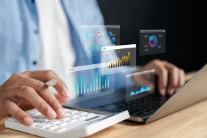 Person typing on laptop with pop out charts and diagrams